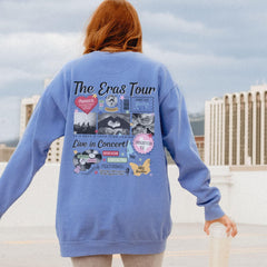 a woman in a blue sweatshirt is holding a skateboard
