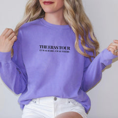 a woman wearing a purple sweatshirt and white shorts