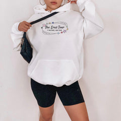 a woman wearing a white hoodie and black shorts