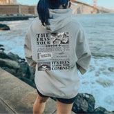 a woman with blue hair wearing a gray hoodie