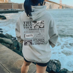 a woman with blue hair wearing a gray hoodie