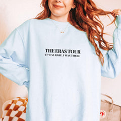 a woman with red hair wearing a blue sweatshirt