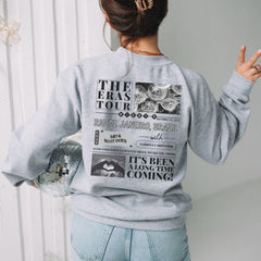a woman wearing a sweatshirt with the words the eras tour on it