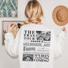 a woman wearing a white sweatshirt and a hat