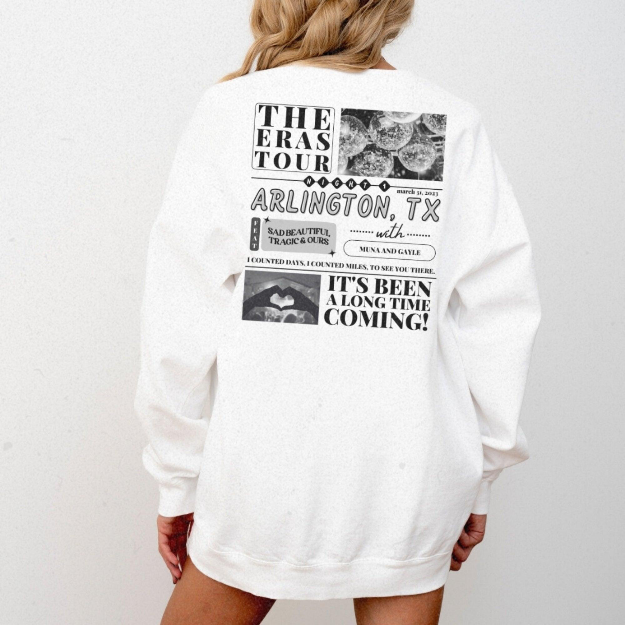 a woman is wearing a white sweatshirt with a picture of a woman's face