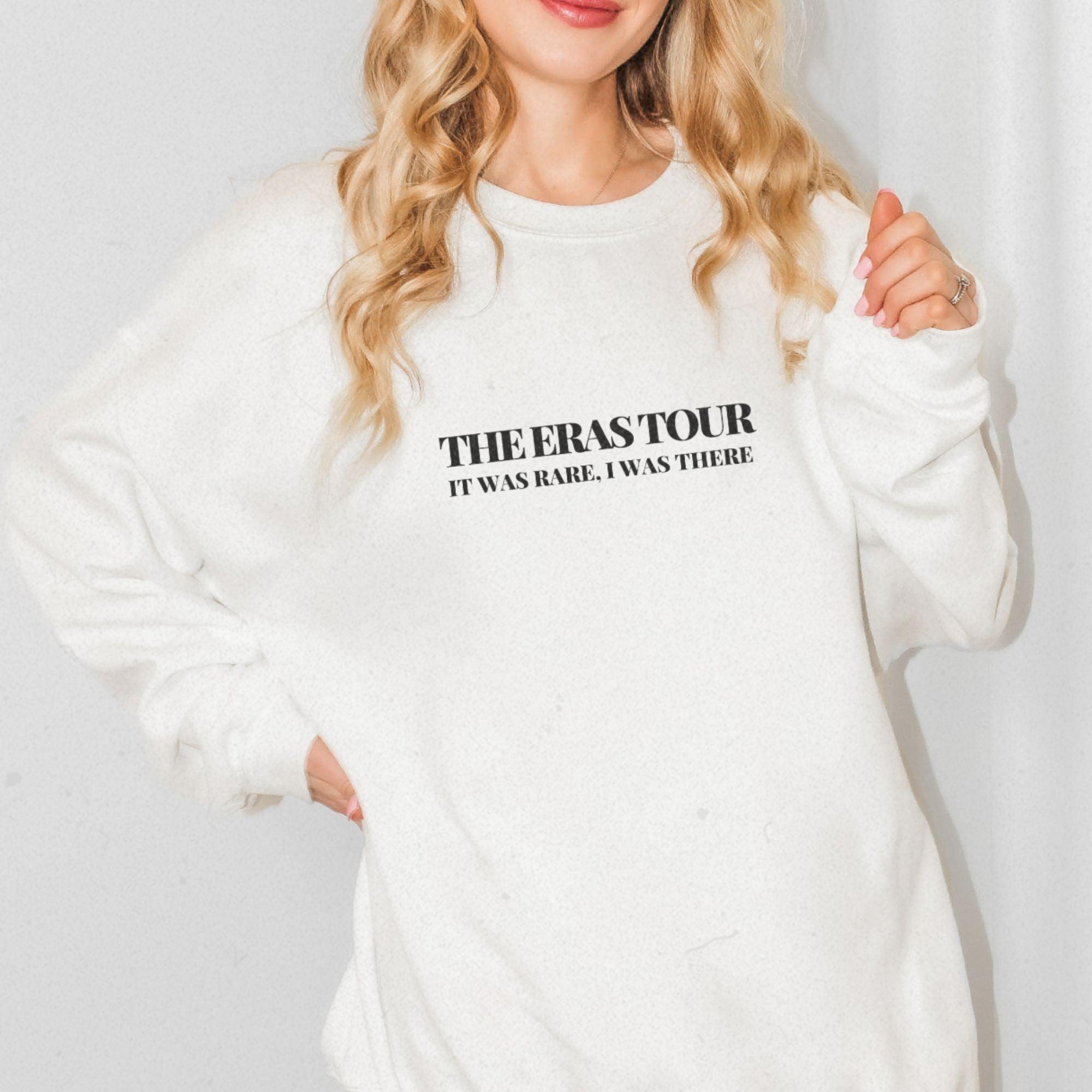 a woman wearing a white sweatshirt with the words, the overstour it's