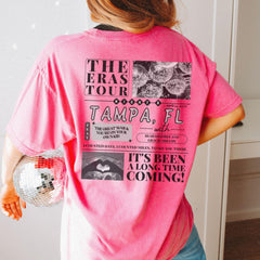 a woman in a pink shirt holding a disco ball