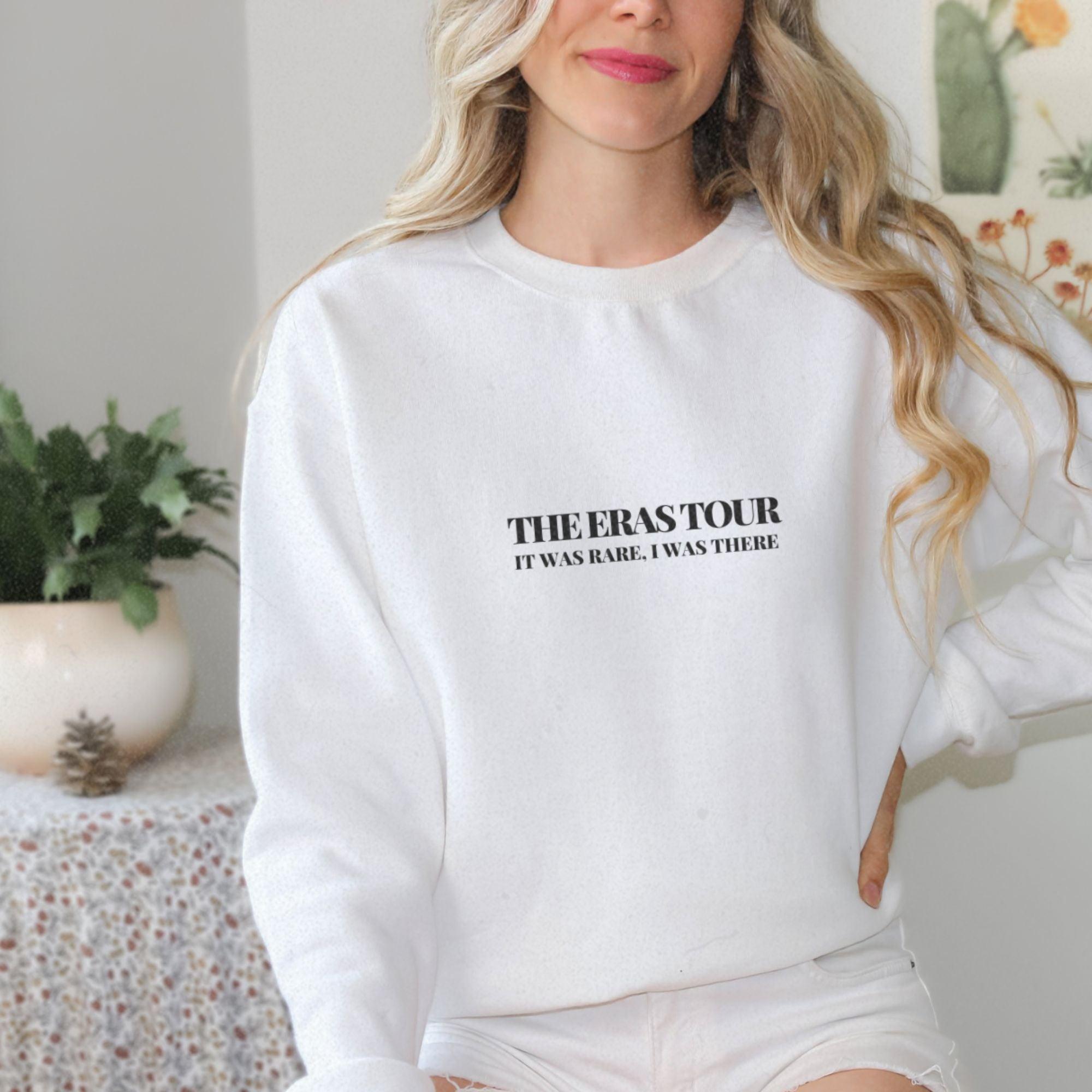 a woman wearing a white sweatshirt and shorts