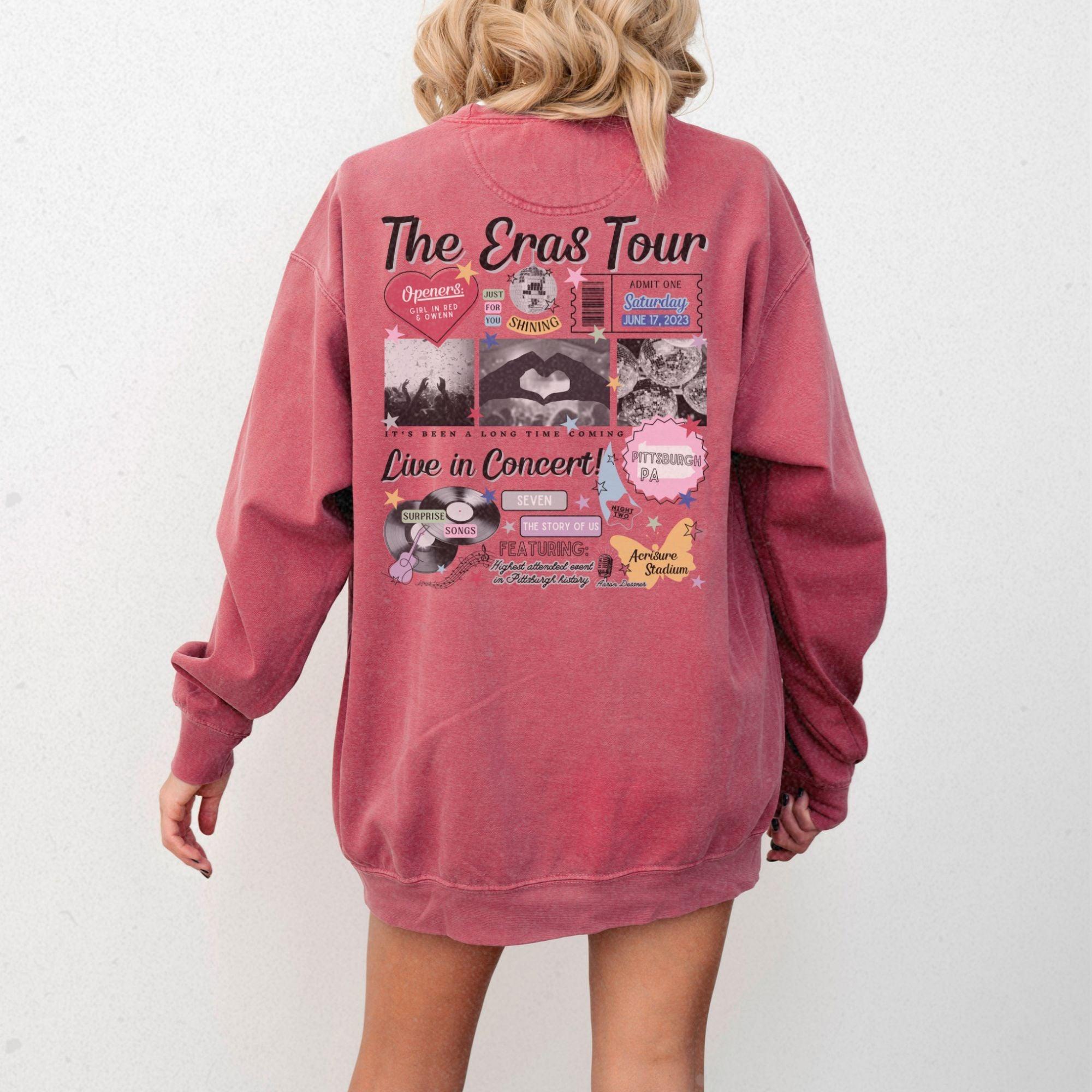 a woman wearing a pink sweatshirt with the words the erics tour printed on it