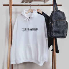 a white sweatshirt hanging on a clothes rack