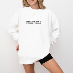 a woman wearing a white sweatshirt and black shorts