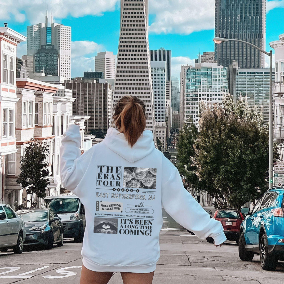 a woman riding a skateboard down a city street