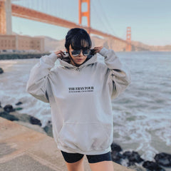 a woman wearing a hoodie with the golden gate bridge in the background