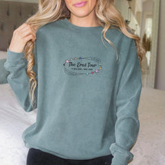 a woman wearing a green sweatshirt and black pants