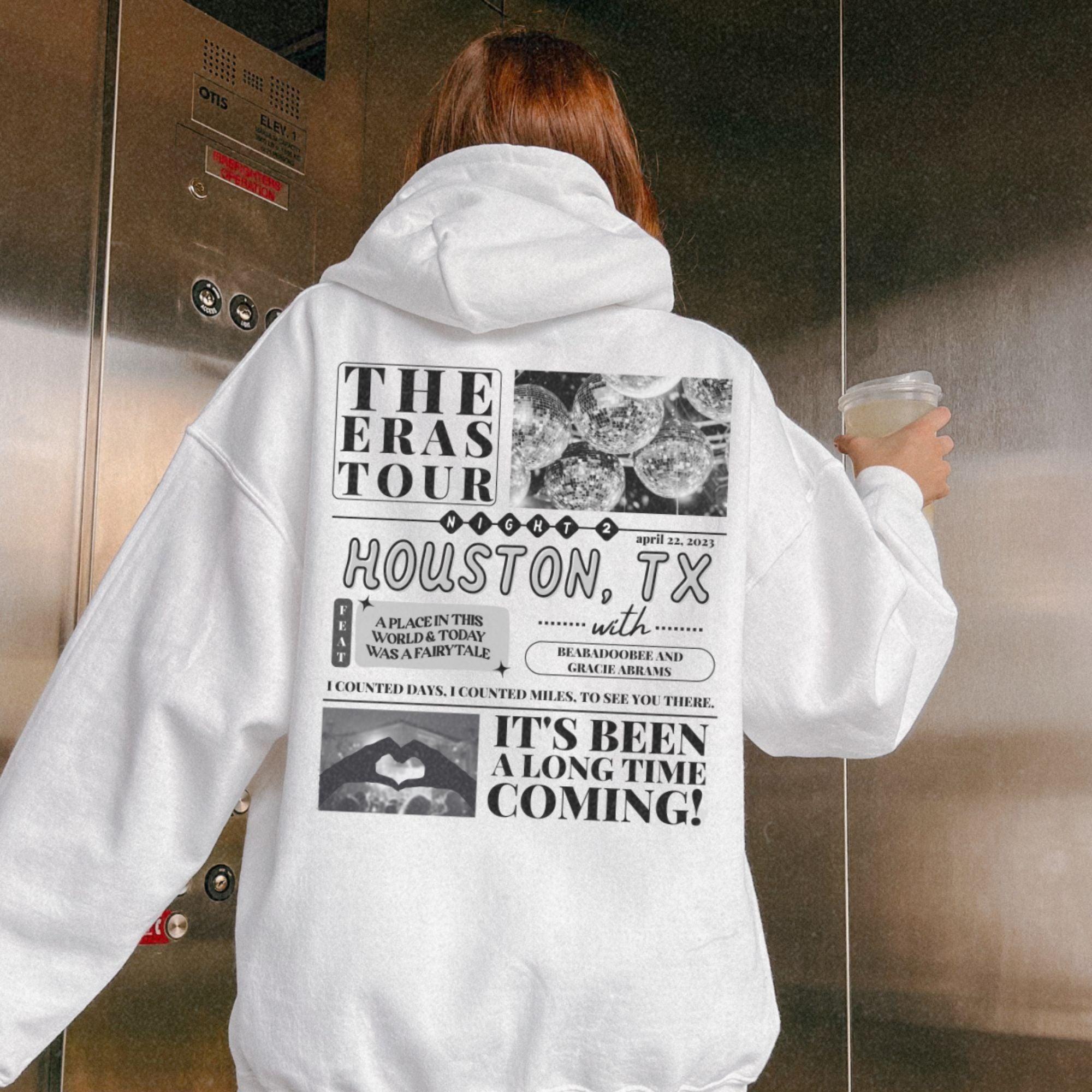 a woman in a white hoodie holding a cup of coffee