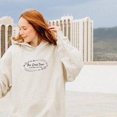 a woman in a white hoodie is holding her hair