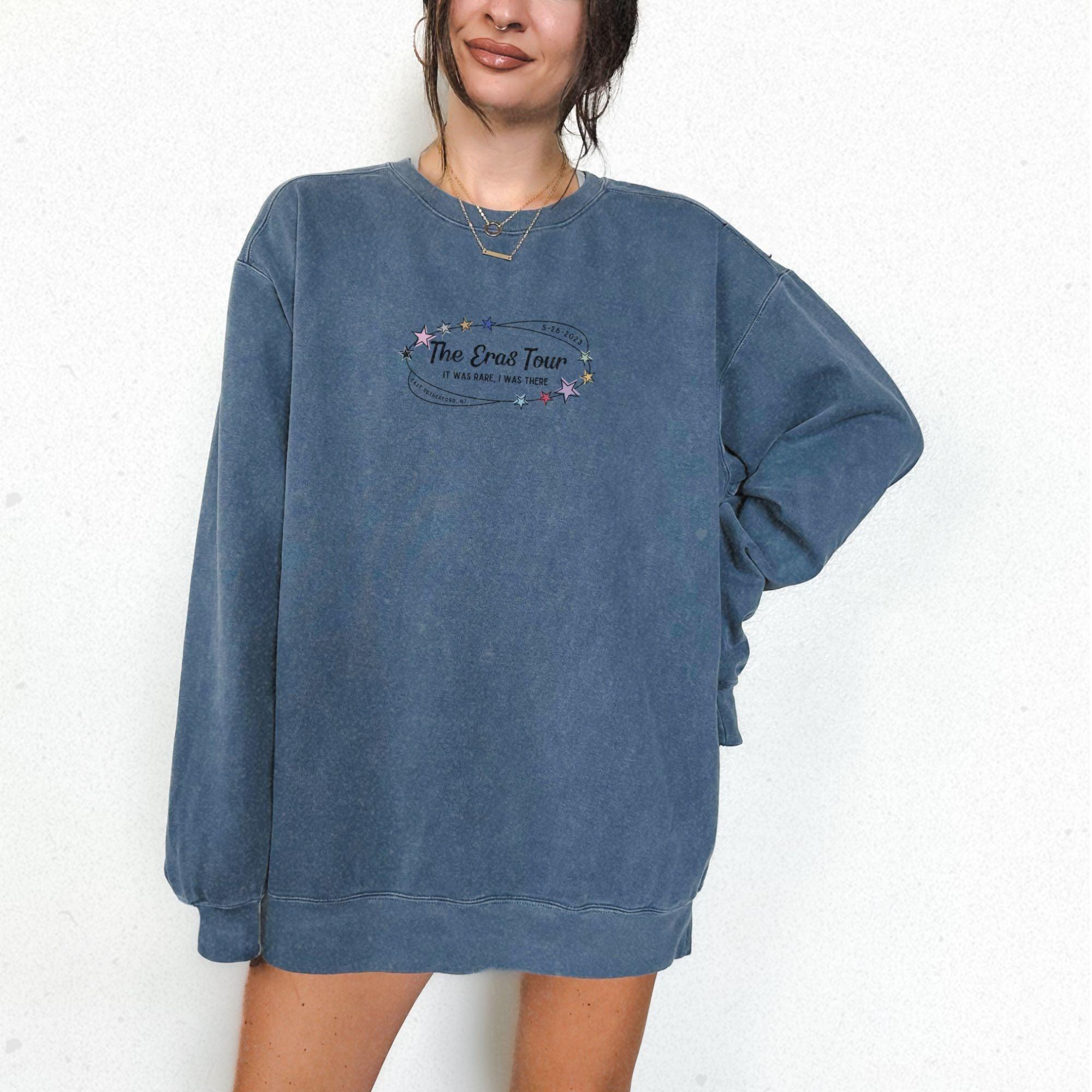 a woman wearing a blue sweatshirt with a message on it