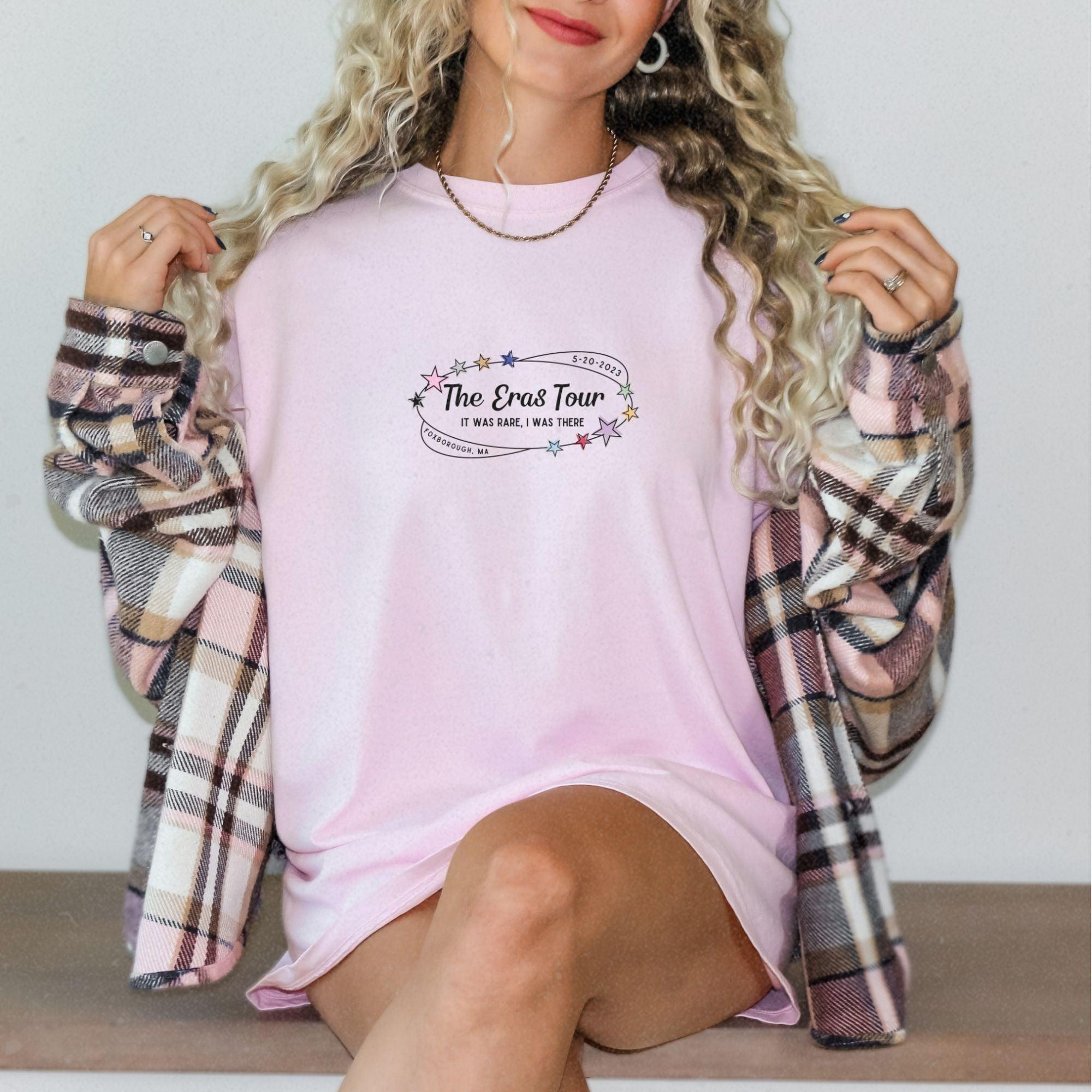 a woman sitting on a bench wearing a pink shirt