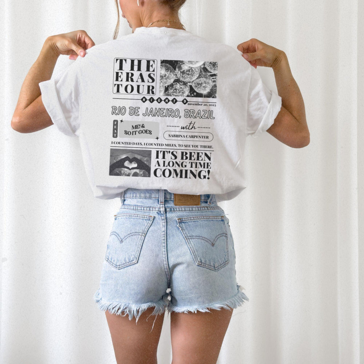 a woman wearing a white shirt and jean shorts