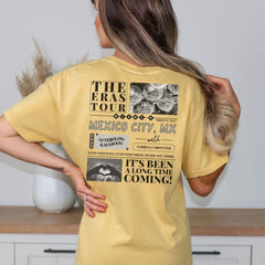a woman standing in a kitchen with her back to the camera