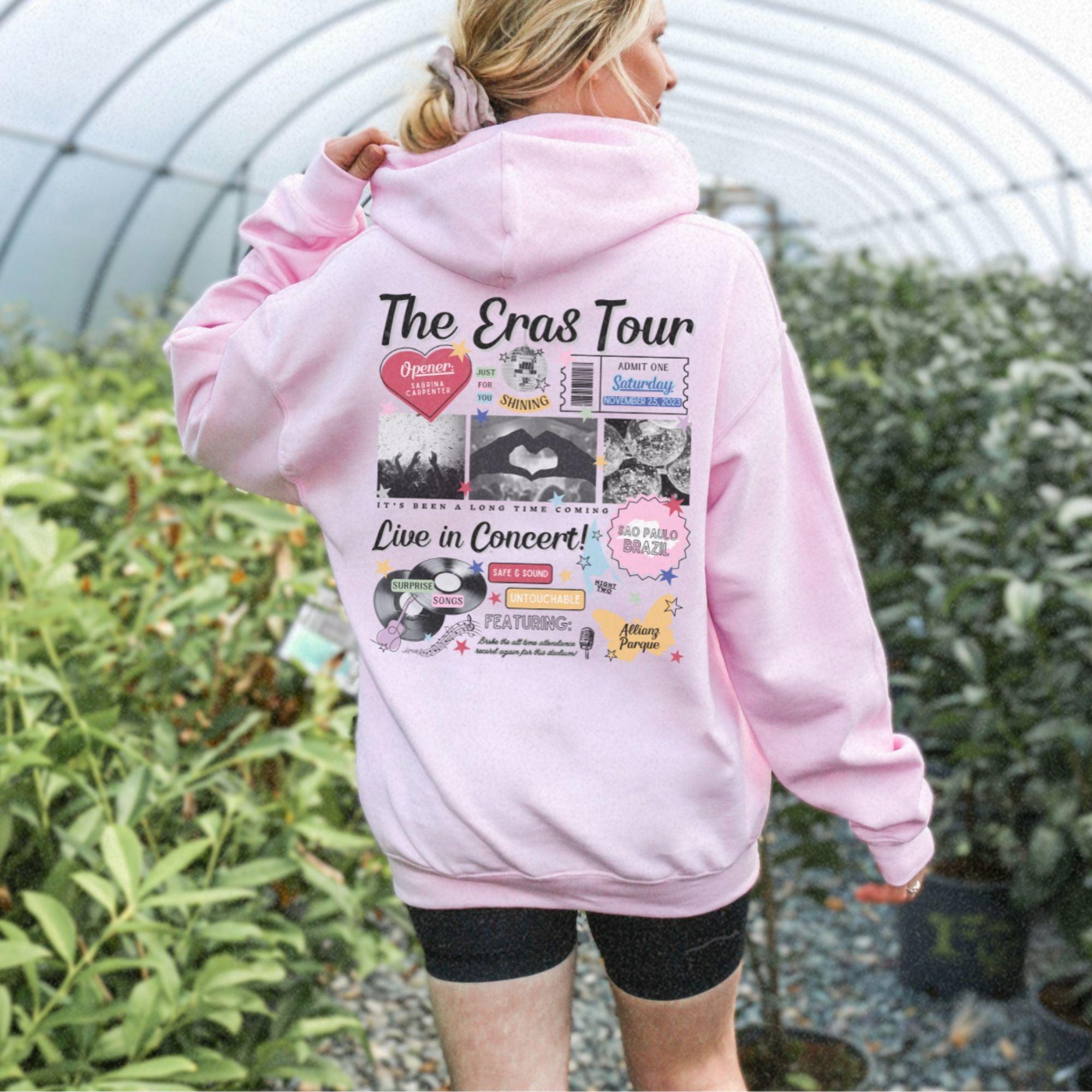 a woman in a pink hoodie is walking through a greenhouse