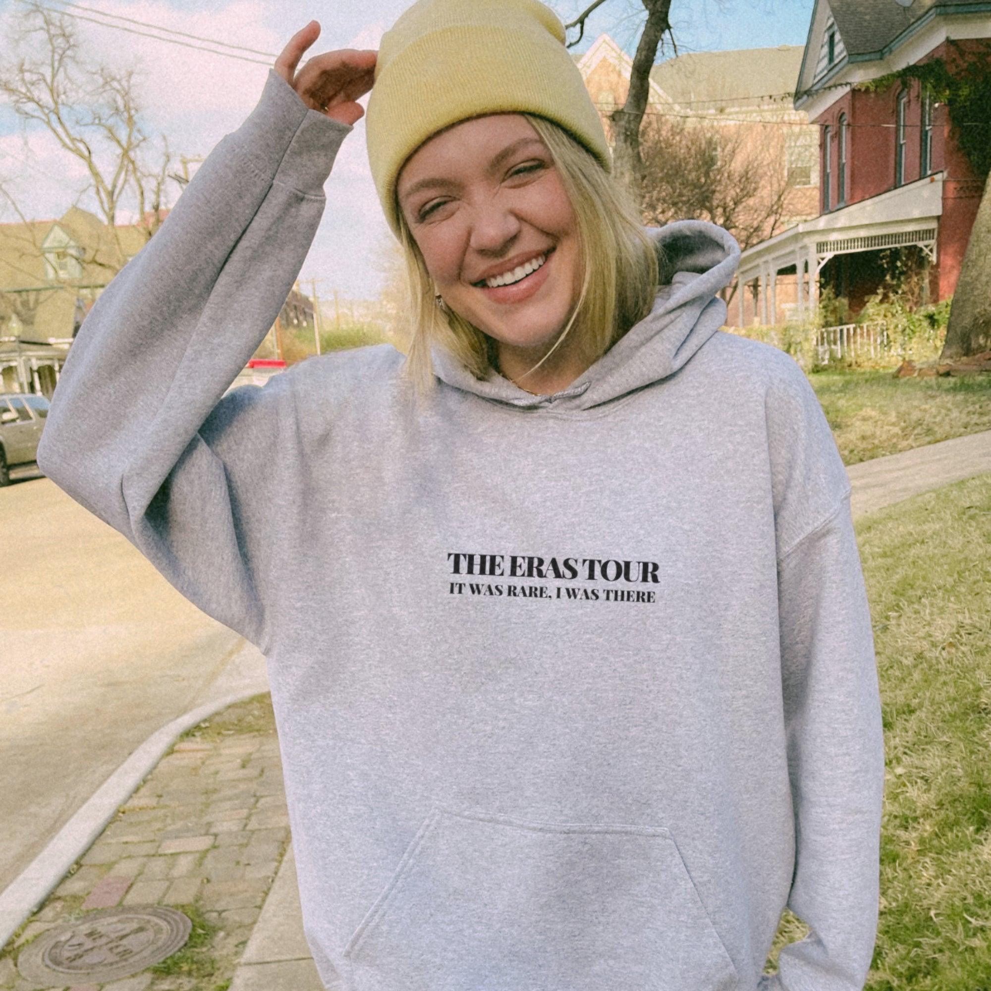 a woman in a grey sweatshirt and a yellow hat