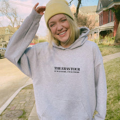 a woman in a grey sweatshirt and a yellow hat