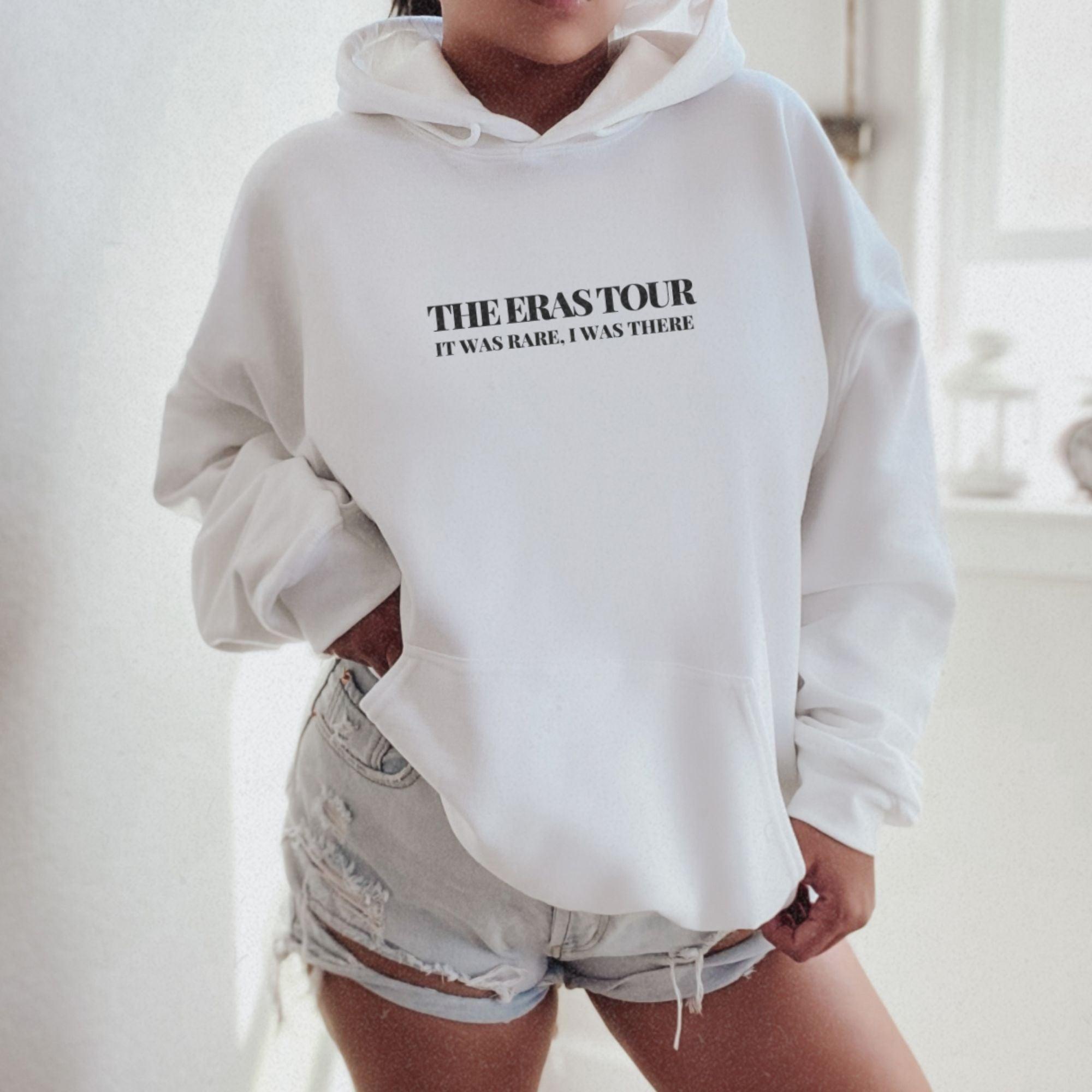 a woman wearing a white sweatshirt and shorts