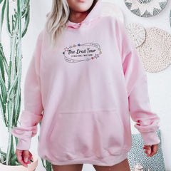 a woman wearing a pink hoodie with the words the great tour on it