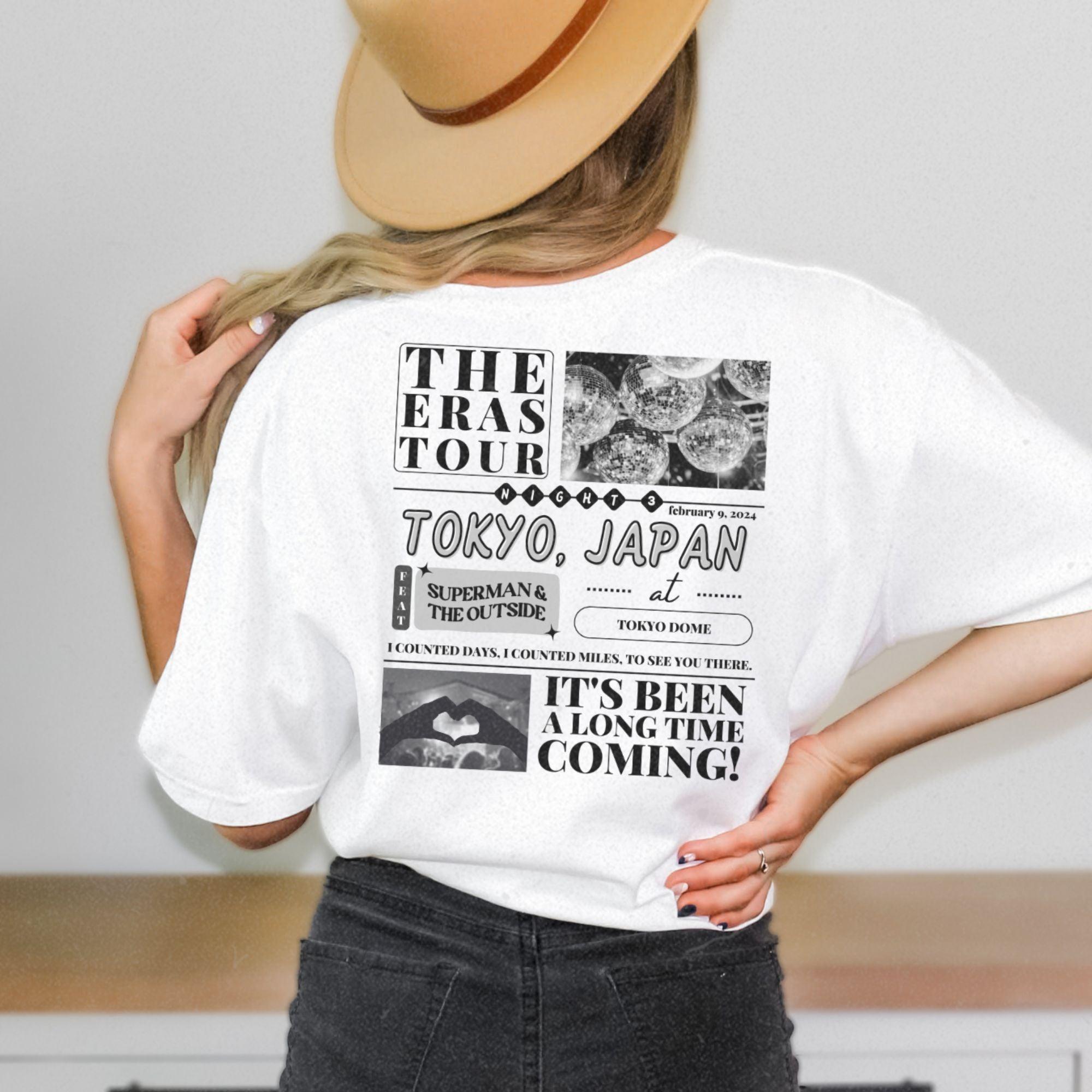 a woman wearing a white tshirt and a hat